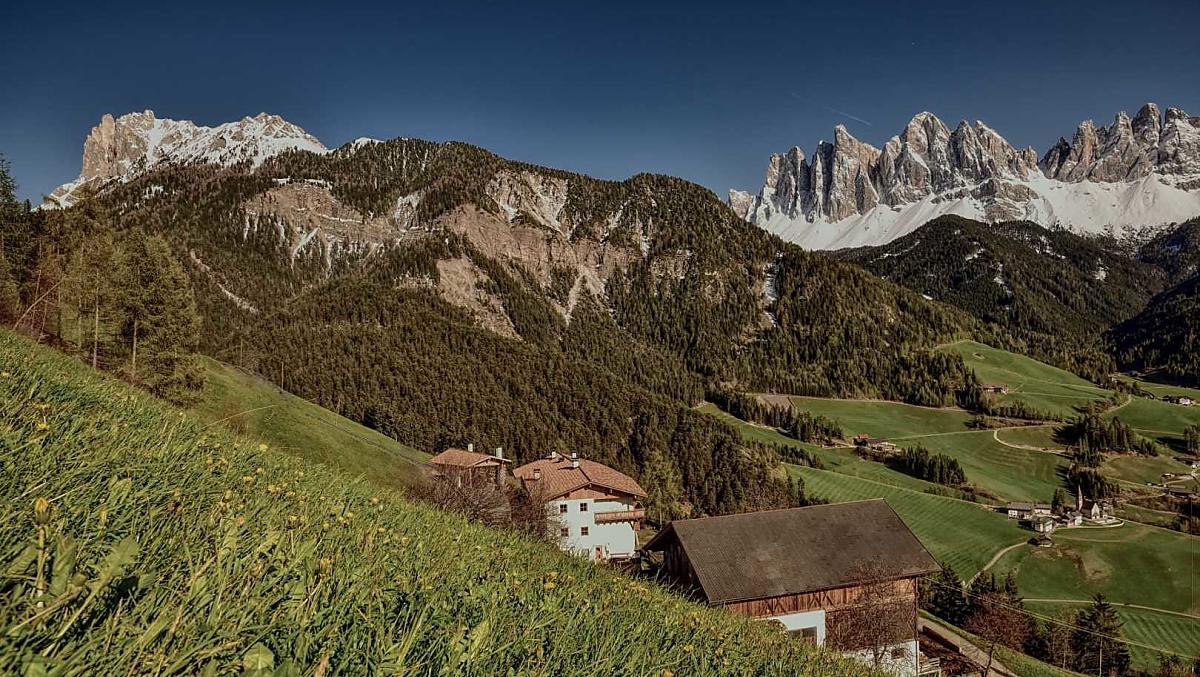 Our mountain farm with the snow-capped Geisler peaks in the background