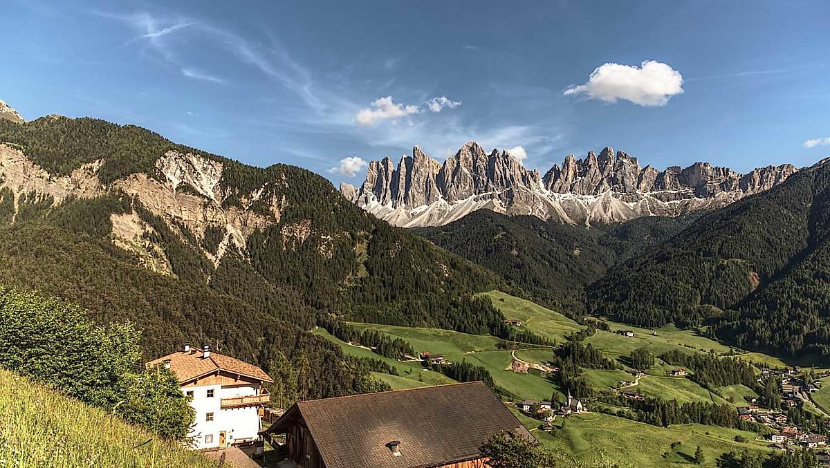Our mountain farm in front of a picturesque mountain landscape