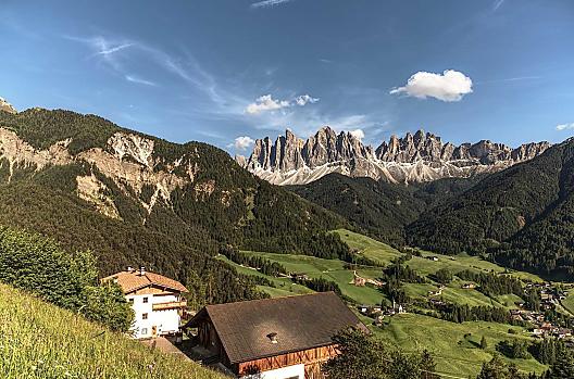 Our mountain farm in front of a picturesque mountain landscape