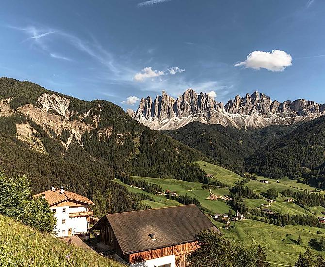 Our mountain farm in front of a picturesque mountain landscape