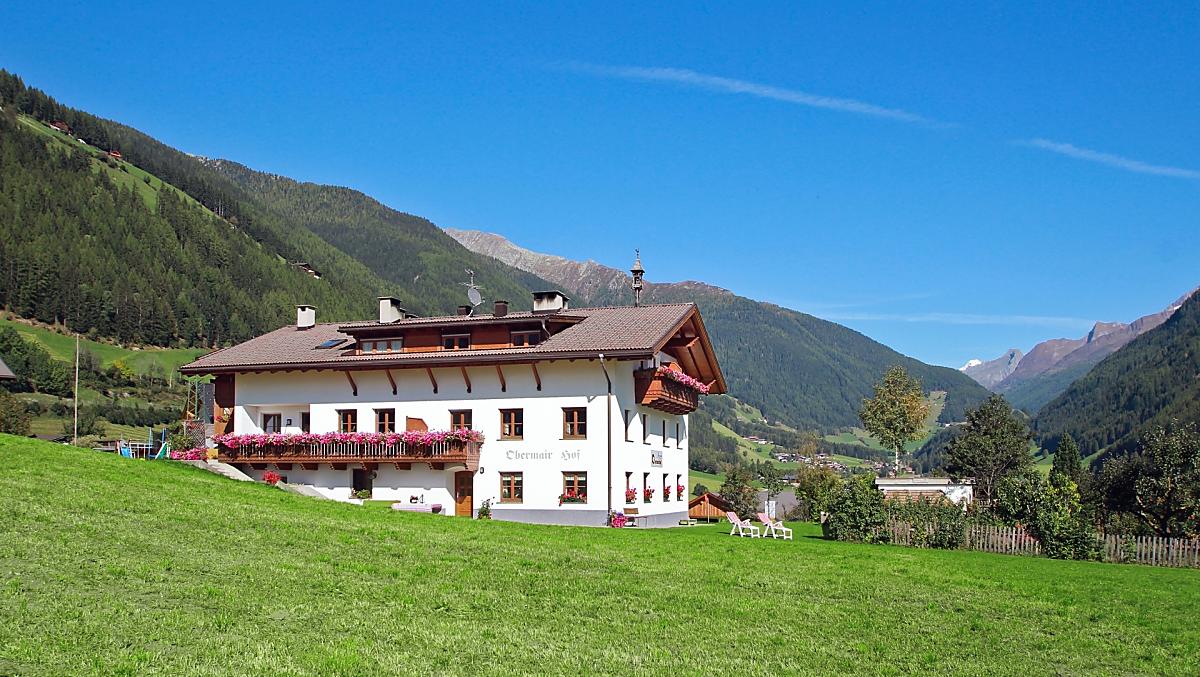 The farm in the middle of its own meadow.