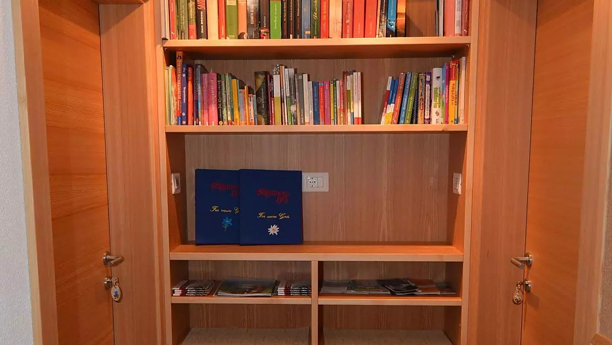 The entrance area to the apartments with a book corner and lots of information about our valley