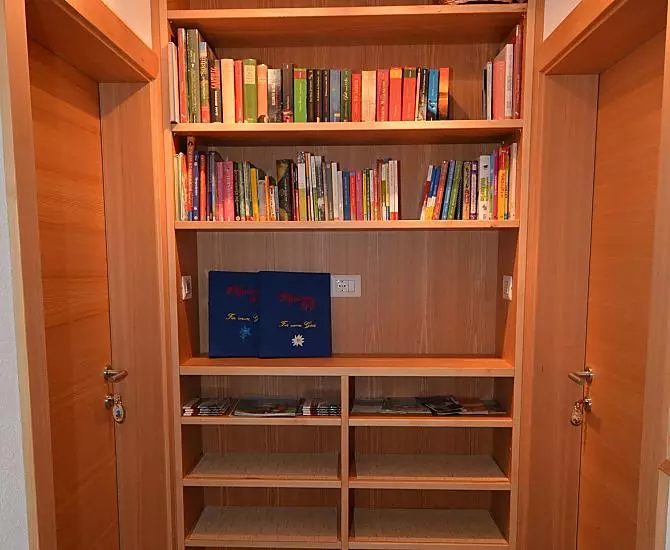 The entrance area to the apartments with a book corner and lots of information about our valley