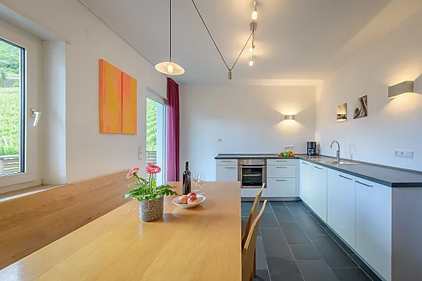 Viel Platz für euren Familien- oder Freundesurlaub - helle Küche mit Südbalkon und angrenzendem Wohnzimmer mit Couch und TV